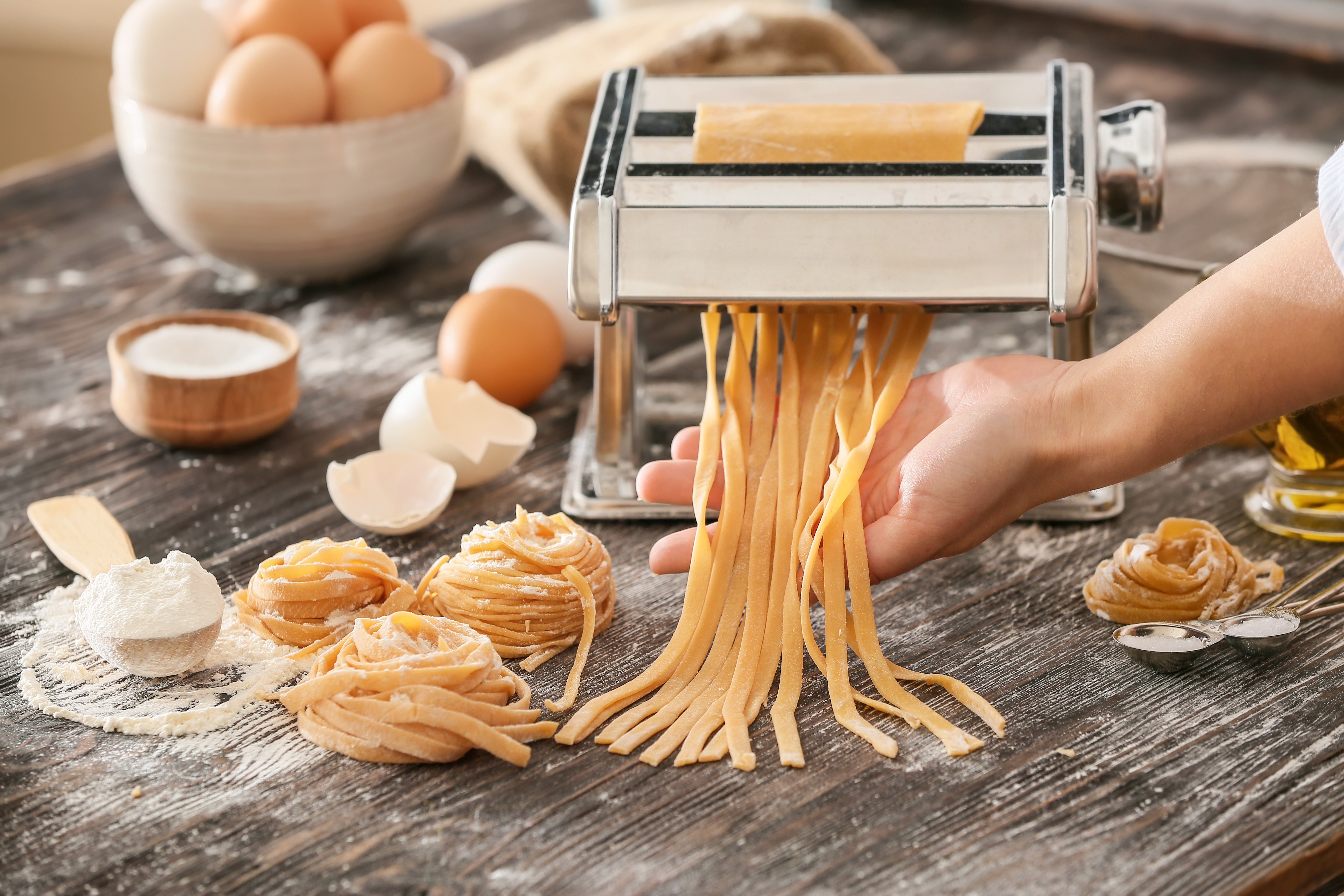 Guests participating in a pasta-making class
